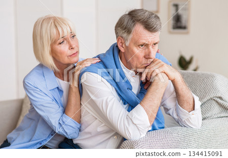 Problems in relationships. Senior woman consoling husband after arguing at home 134415091