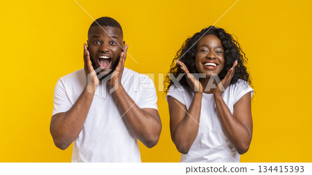 Emotional Black Couple Touching Cheeks On Yellow Background, panorama Emotional Black Couple Touching Cheeks On Yellow Background, panorama 134415393