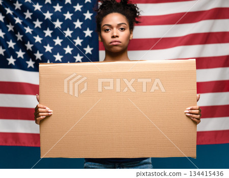 Mass ptotests in USA. Black girl standing with blank cardboard over american flag Mass ptotests in USA. Black girl standing with blank cardboard over american flag 134415436