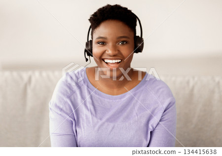 Operator Of Hot Line. Portrait of cheerful female african american customer service representative wearing headset in call center, looking at camera and smiling. Support, Contact Us Operator Of Hot Line. Portrait of cheerful female african american customer service representative wearing headset in call center, looking at camera and smiling. Support, Contact Us 134415638