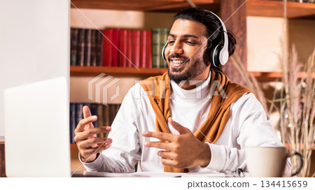 Online Teacher. Cheerful Indian Tutor Having Virtual Class Teaching Online Sitting At Laptop Computer And Explaining Lesson Indoors. E-Teaching, Distant Education Concept Online Teacher. Cheerful Indian Tutor Having Virtual Class Teaching Online Sitting At Laptop Computer And Explaining Lesson Indoors. E-Teaching, Distant Education Concept 134415659
