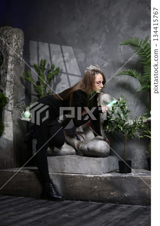 Female artist captures statue with intimate foliage background shot 134415767
