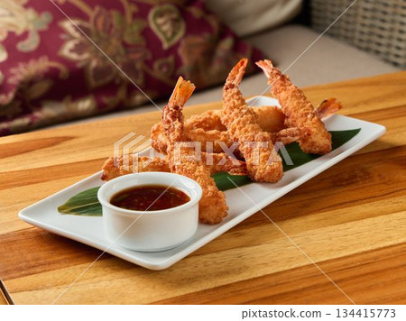 Delicious crispy shrimp tempura presented on rectangular dish alongside savory dipping sauce Delicious crispy shrimp tempura presented on rectangular dish alongside savory dipping sauce 134415773