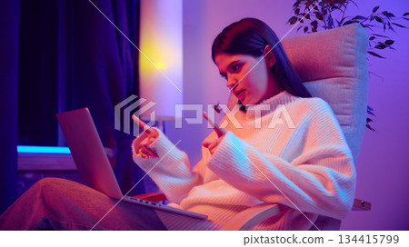Young woman talking during business video call on laptop. 134415799