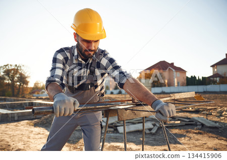 Metal rog, busy. Worker is on the construction site at daytime Metal rog, busy. Worker is on the construction site at daytime 134415906