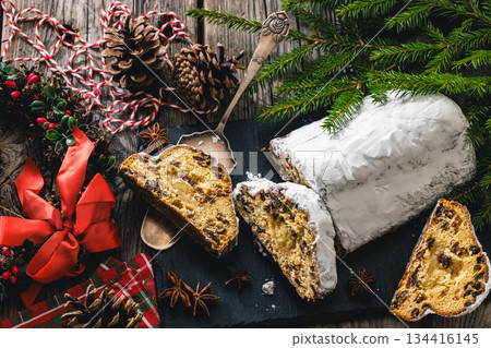 Stollen with filling of raisins, candied fruit 134416145