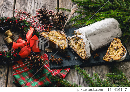 Stollen with filling of raisins, candied fruit 134416147