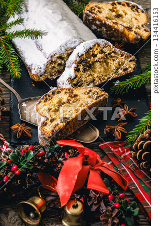 Stollen with filling of raisins, candied fruit 134416153