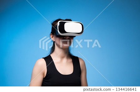 Woman using VR headset in futuristic digital world Woman using VR headset in futuristic digital world 134416641