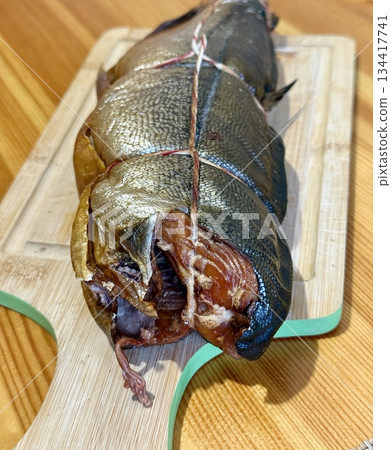 Cold hot smoked mackerel, beautifully laid out on a wooden chopping board, is ready for cooking and serving and is perfect for culinary themes. Cold hot smoked mackerel, beautifully laid out on a wooden chopping board, is ready for cooking and serving and is perfect for culinary themes. 134417741