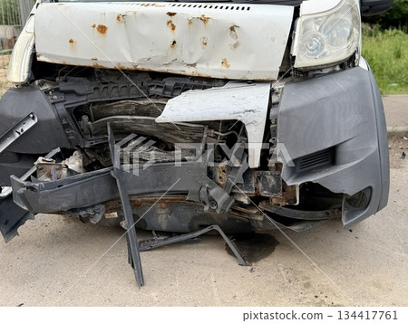 This minibus was significantly damaged as a result of a serious head-on collision. A seriously damaged grey minibus, which shows significant collision marks in the front and extensive rust marks. This minibus was significantly damaged as a result of a serious head-on collision. A seriously damaged grey minibus, which shows significant collision marks in the front and extensive rust marks. 134417761
