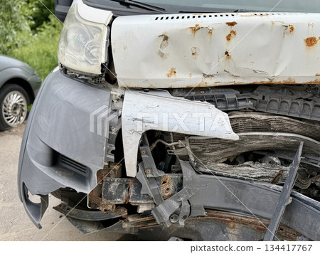 This minibus was significantly damaged as a result of a serious head-on collision. A seriously damaged grey minibus, which shows significant collision marks in the front and extensive rust marks. This minibus was significantly damaged as a result of a serious head-on collision. A seriously damaged grey minibus, which shows significant collision marks in the front and extensive rust marks. 134417767