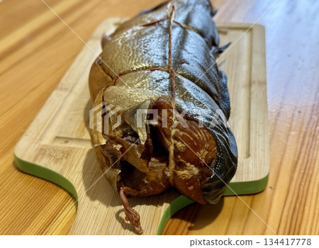 Cold hot smoked mackerel, beautifully laid out on a wooden chopping board, is ready for cooking and serving and is perfect for culinary themes. Cold hot smoked mackerel, beautifully laid out on a wooden chopping board, is ready for cooking and serving and is perfect for culinary themes. 134417778