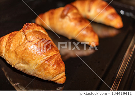Freshly baked croissants in the oven Freshly baked croissants in the oven 134419411