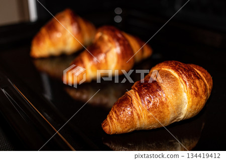 Freshly baked croissants in the oven Freshly baked croissants in the oven 134419412