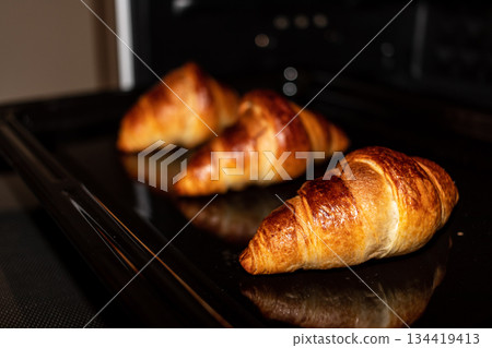 Freshly baked croissants in the oven Freshly baked croissants in the oven 134419413