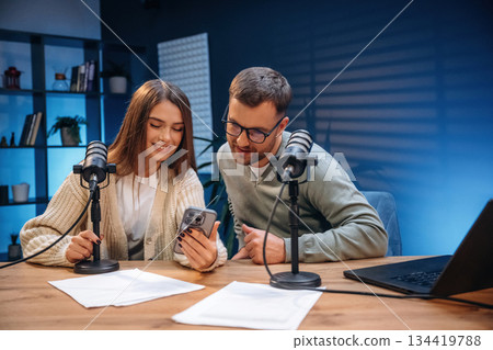 Tow people, together. Radio hosts recording podcast Tow people, together. Radio hosts recording podcast 134419788