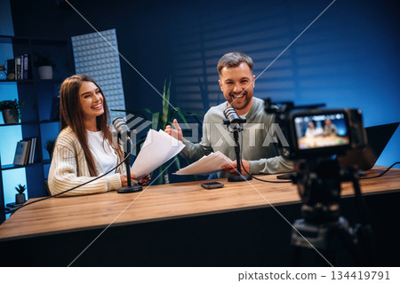 Tow people, together. Radio hosts recording podcast 134419791