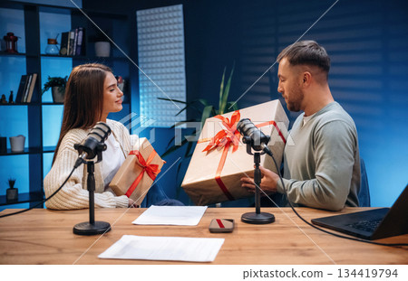 New year is coming, with gift boxes. Radio hosts recording podcast 134419794