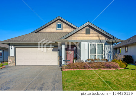 Wide garage of a nice residential house on bright winter day in British Columbia, Canada Wide garage of a nice residential house on bright winter day in British Columbia, Canada 134420139