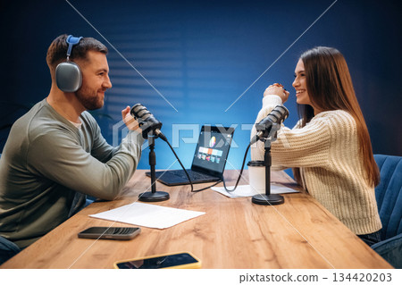 In the studio, talking. Radio hosts recording podcast In the studio, talking. Radio hosts recording podcast 134420203