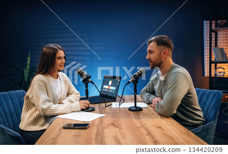 Having a conversation. Radio hosts recording podcast Having a conversation. Radio hosts recording podcast 134420209