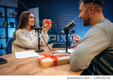 Man and woman are sitting. Radio hosts recording podcast Man and woman are sitting. Radio hosts recording podcast 134420216