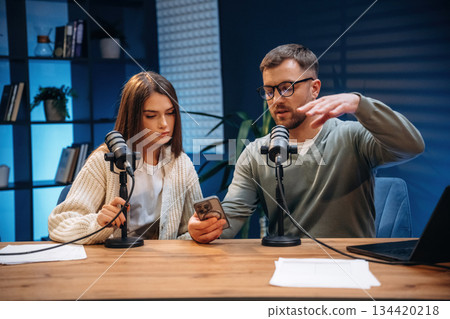 Microphones are on the table, talking. Radio hosts recording podcast Microphones are on the table, talking. Radio hosts recording podcast 134420218