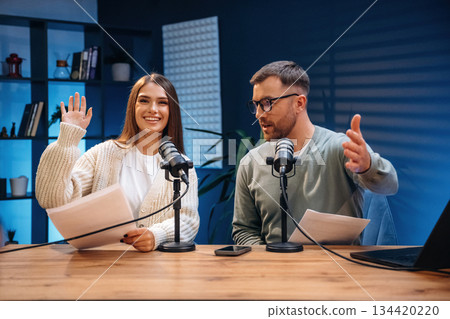 Microphones are on the table, talking. Radio hosts recording podcast Microphones are on the table, talking. Radio hosts recording podcast 134420220