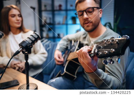 Singing with passion. Male musician on the radio podcast with female host Singing with passion. Male musician on the radio podcast with female host 134420225