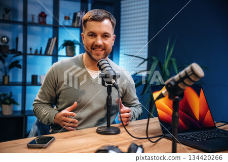 Man with microphone in the studio, conception of podcast Man with microphone in the studio, conception of podcast 134420266