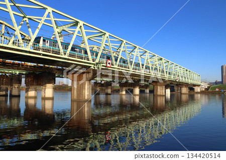 Keihin-Tohoku Line E233 series train crossing the Arakawa Bridge in winter 134420514