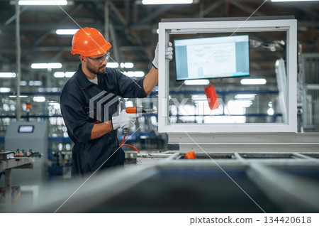 Using screwdriver. Man is working in the modern factory 134420618