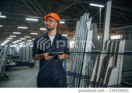 With digital tablet. Man is working in the modern factory 134420681