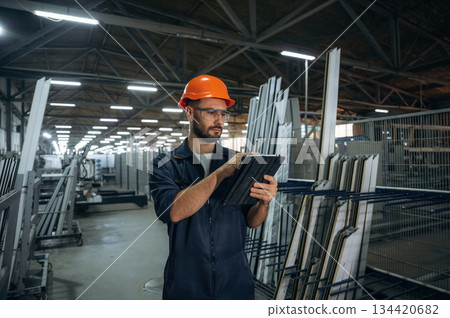 With digital tablet. Man is working in the modern factory 134420682