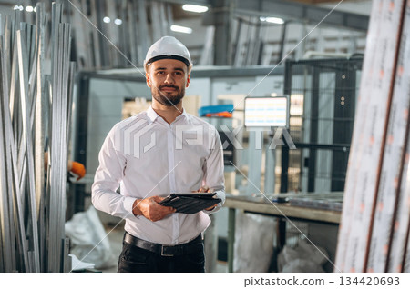 Modern digital tablet. Man is working in the modern factory Modern digital tablet. Man is working in the modern factory 134420693
