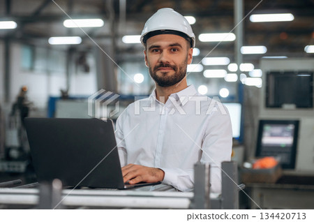 Busy at work. Man is in the modern factory Busy at work. Man is in the modern factory 134420713