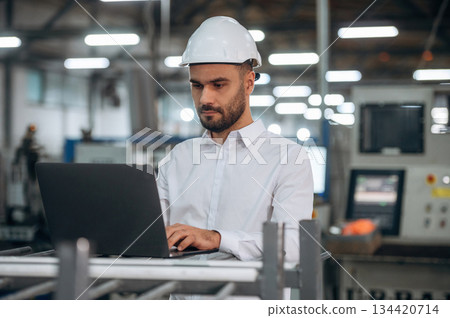 Busy at work. Man is in the modern factory 134420714