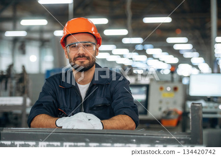 Professional mechanic or technician, standing. Man is working in the modern factory 134420742
