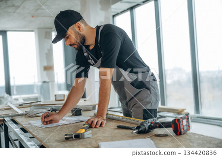 Table with tools. A man is renovating an unfinished room Table with tools. A man is renovating an unfinished room 134420836