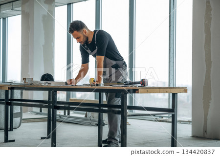 Table with tools. A man is renovating an unfinished room 134420837