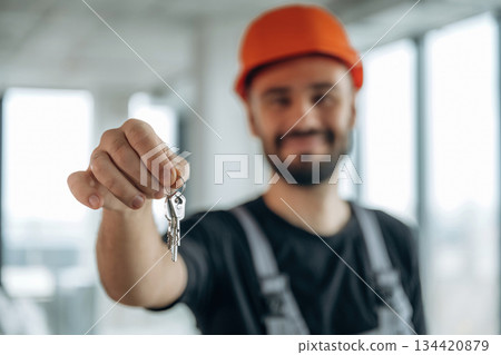 Buy it. Happy construction worker is holding keys for new home Buy it. Happy construction worker is holding keys for new home 134420879