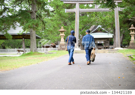 Two people heading towards the torii gate Two people heading towards the torii gate 134421189