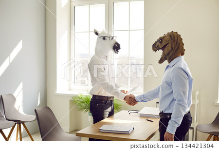 Happy colleagues shaking hands at meeting at office, celebrating success or business achievement 134421304