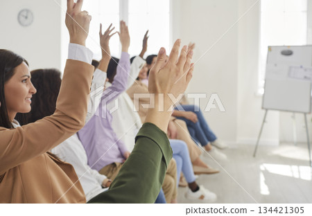 Business women at the conference raising hands voting in the office. Business women at the conference raising hands voting in the office. 134421305
