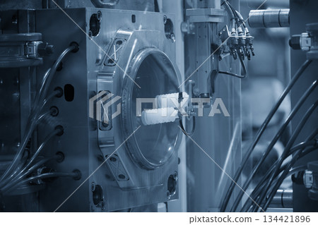 Close up scene material handling process the food container by robotic system from injection machine. 134421896