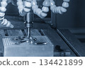 The CNC milling machine rough cutting the injection mold parts by indexable tools in the light blue scene. 134421899