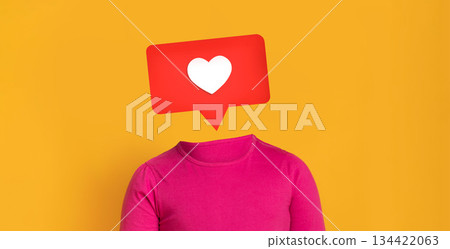 A vibrant yellow backdrop highlights a pink shirted figure with a speech bubble featuring a heart symbol. This illustration represents social media interaction and engagement. A vibrant yellow backdrop highlights a pink shirted figure with a speech bubble featuring a heart symbol. This illustration represents social media interaction and engagement. 134422063