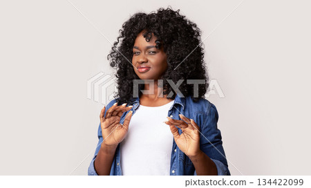 Portrait of black woman feeling unpleasant scent or showing disregard, african american lady suffering from stench, smelly sweaty person bring discomfort, looking at camera and raising hands 134422099