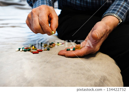 Man preparing medication on a soft surface at home during the afternoon Man preparing medication on a soft surface at home during the afternoon 134422732
